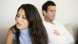 A couple on a couch, possibly discussing marital dissatisfaction.
