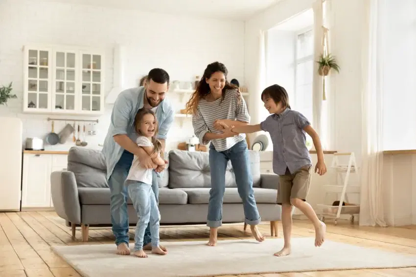 A joyful family enjoying quality time together in their living room, showcasing warmth and togetherness.