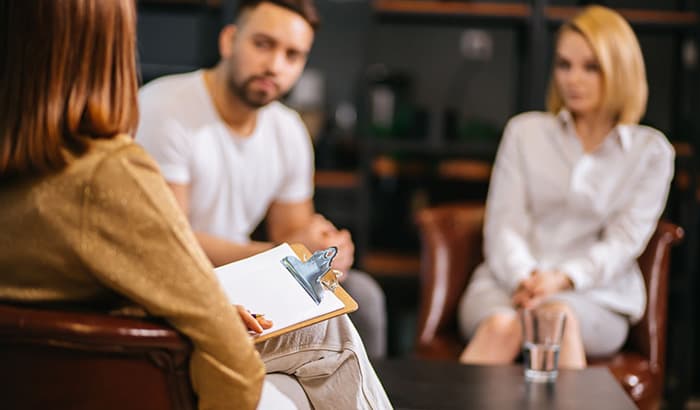 A man and woman discussing their matters with Family Attorneys at Law in Utah, focusing on divorce and family law