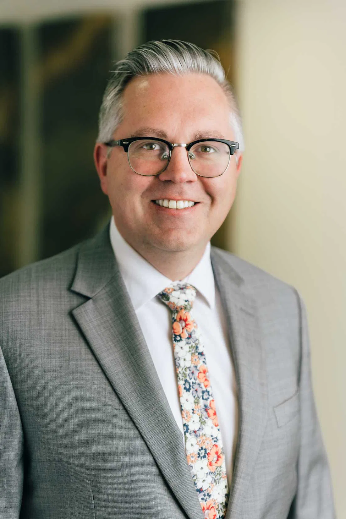 Michael B. Lundberg, Senior Associate Attorney, A man in a suit and tie smiling confidently, exuding professionalism and approachability.