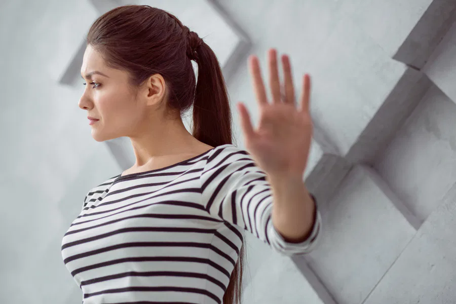 A woman is waving her hand in front of her, representing the Burton Family Attorneys firm.