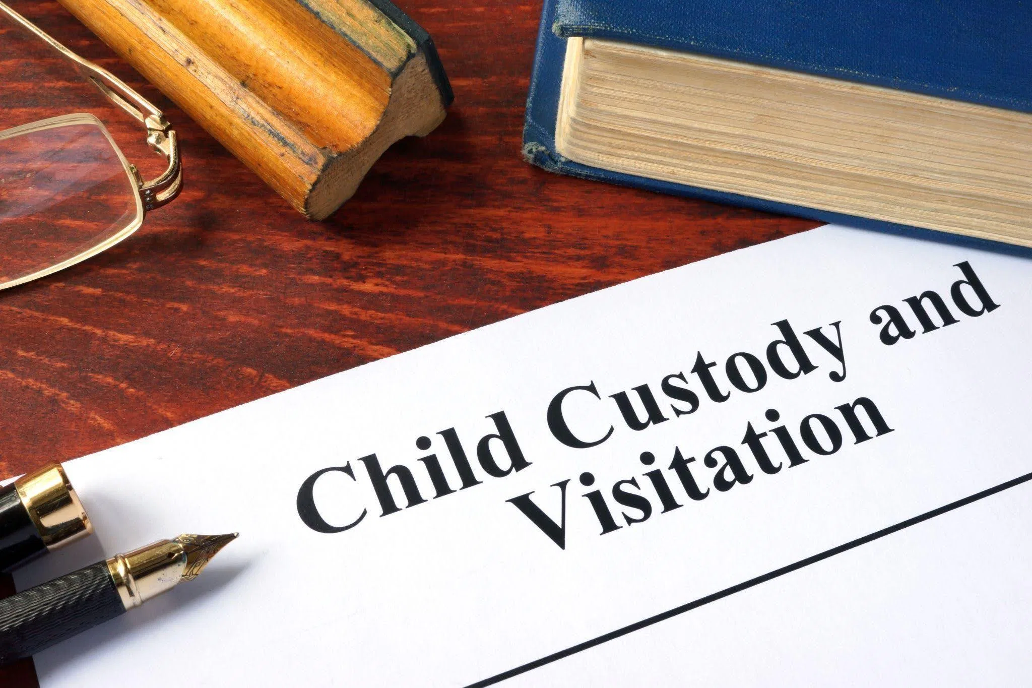A gavel and family photo symbolizing child custody and visitation arrangements in a legal context