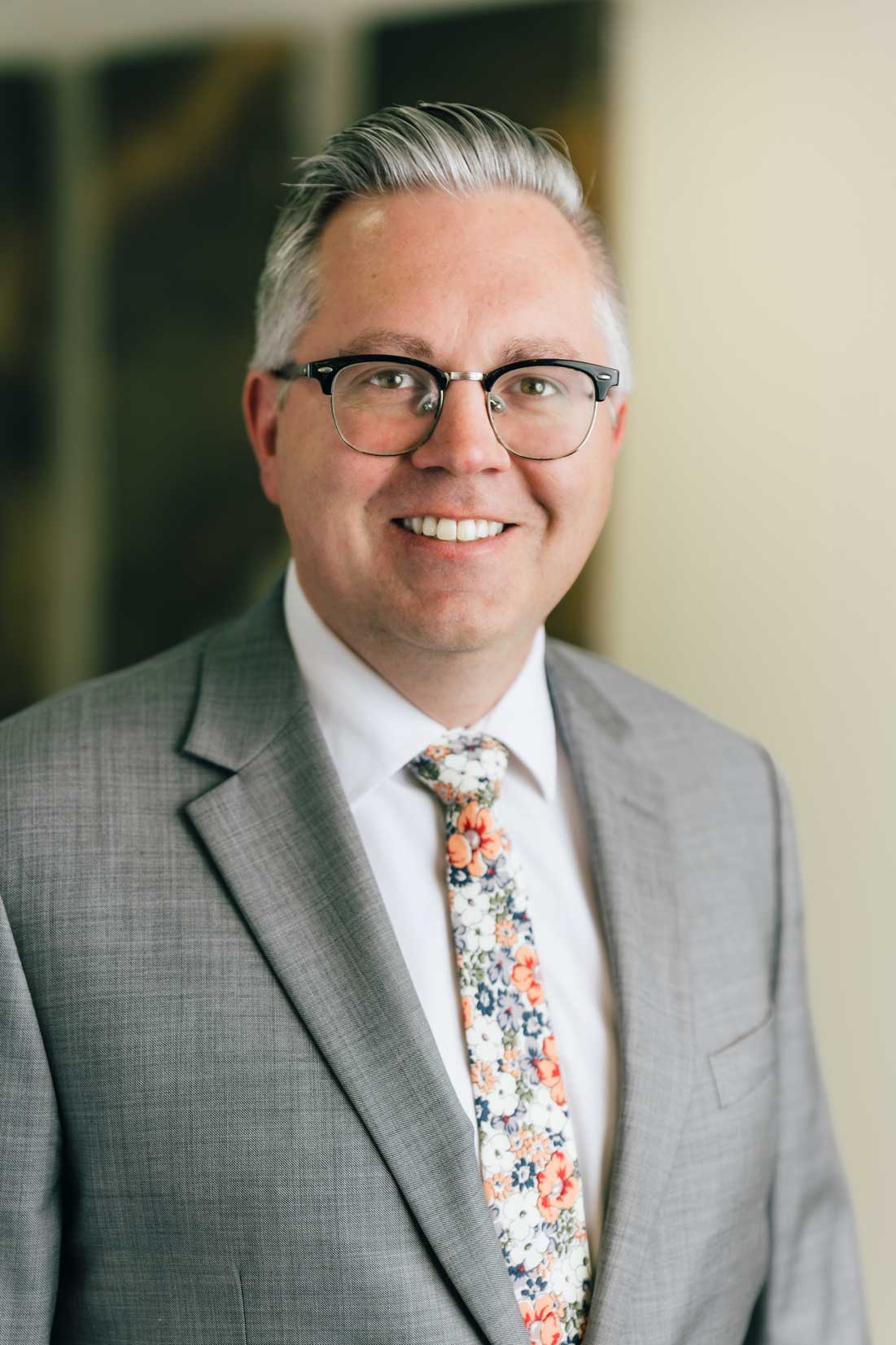 Michael B. Lundberg, Senior Associate Attorney, A man in a suit and tie smiling confidently, exuding professionalism and approachability.